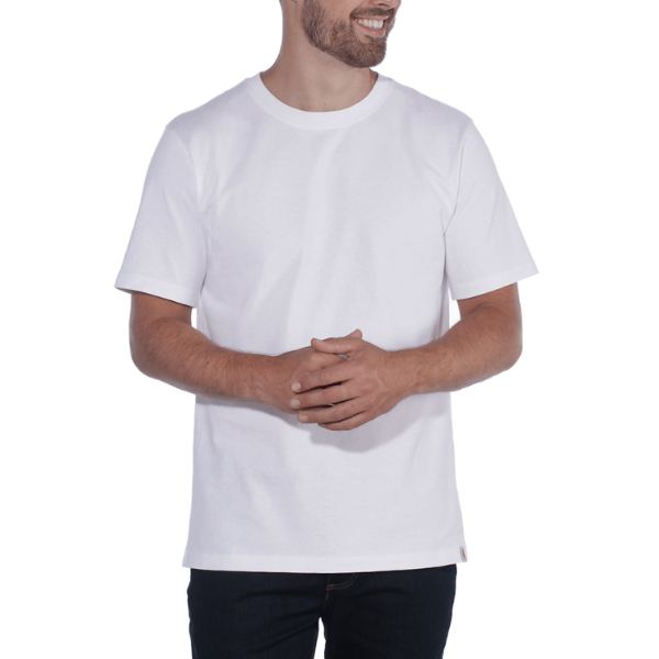 A man with a short beard smiles while wearing a Carhartt TK4264 Relaxed Fit Mediumweight Short Sleeve T-Shirt in white and dark jeans, standing against a white background with his hands clasped at his waist.