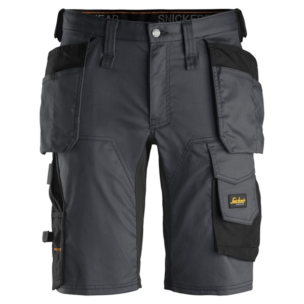 Snickers 6141 AllroundWork Stretch Shorts in black feature multiple holster pockets, loops, and reinforced areas for durability. A yellow Snickers Workwear logo patch is visible on one pocket. Shorts are shown front-facing.