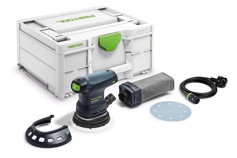 A Festool sander kit with a sanding tool, dust collection bag, power cord, sanding disc, plastic guard, and a white storage case with a green latch, all arranged on a white surface.