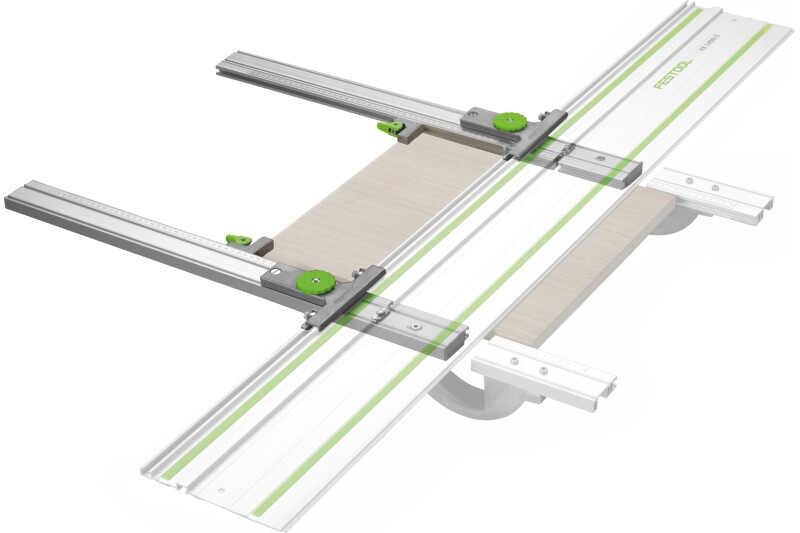 A Festool guide rail system with two green adjustment knobs, holding a piece of wood in place for precise cutting. The system features metal rails and measurement markers for accuracy.
