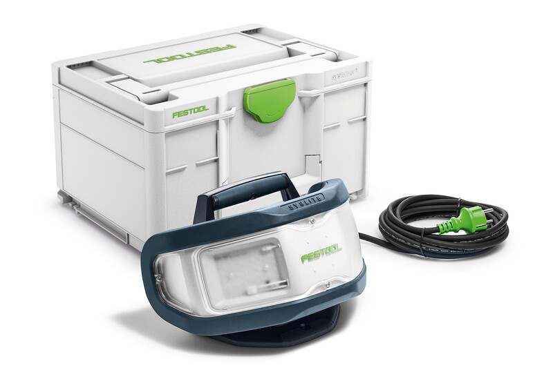 A Festool portable work light with a handle, shown in front of a white storage case with green accents and accompanied by a long black power cord with a green plug.