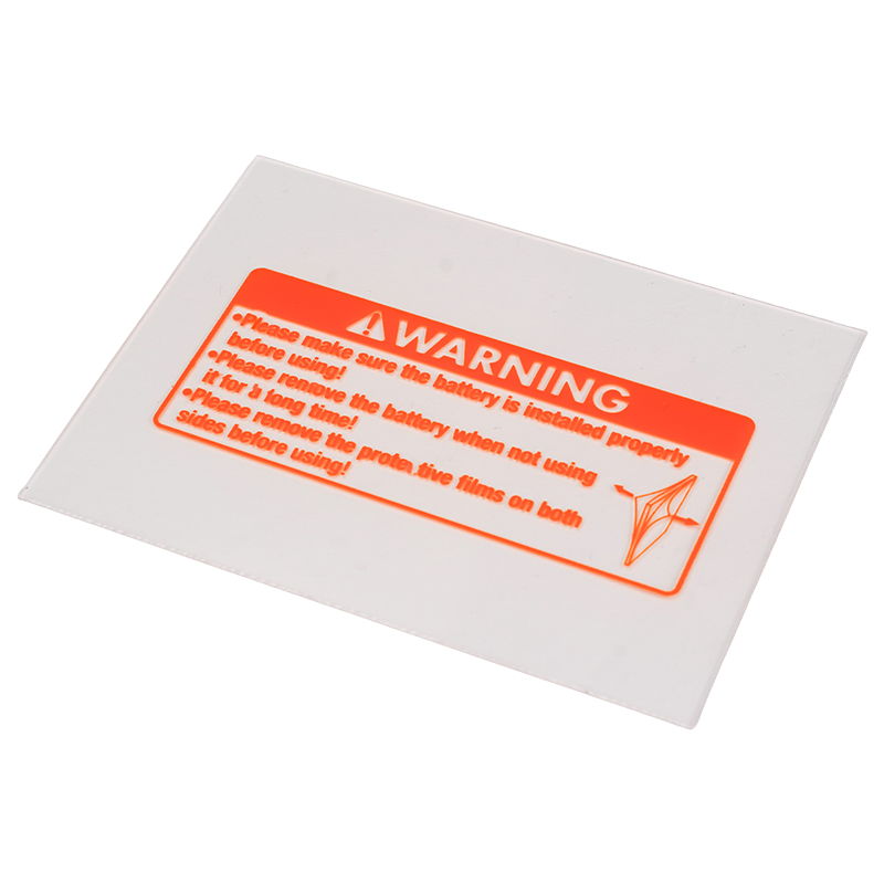 A rectangular clear plastic sheet with an orange warning label, featuring safety instructions and a warning symbol, advising proper battery installation and removal of protective films before use.