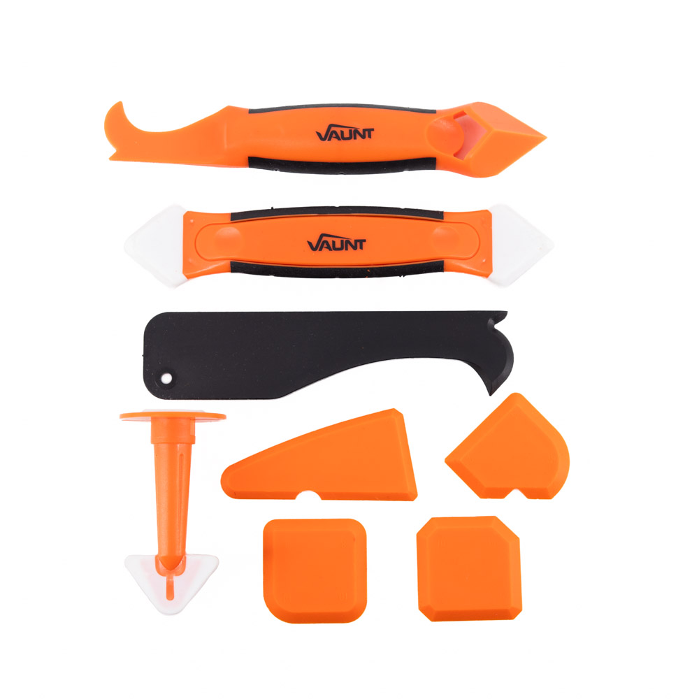 A set of orange and black caulking tools, including scrapers, applicators, and finishing tools with white edges, arranged neatly on a white background.