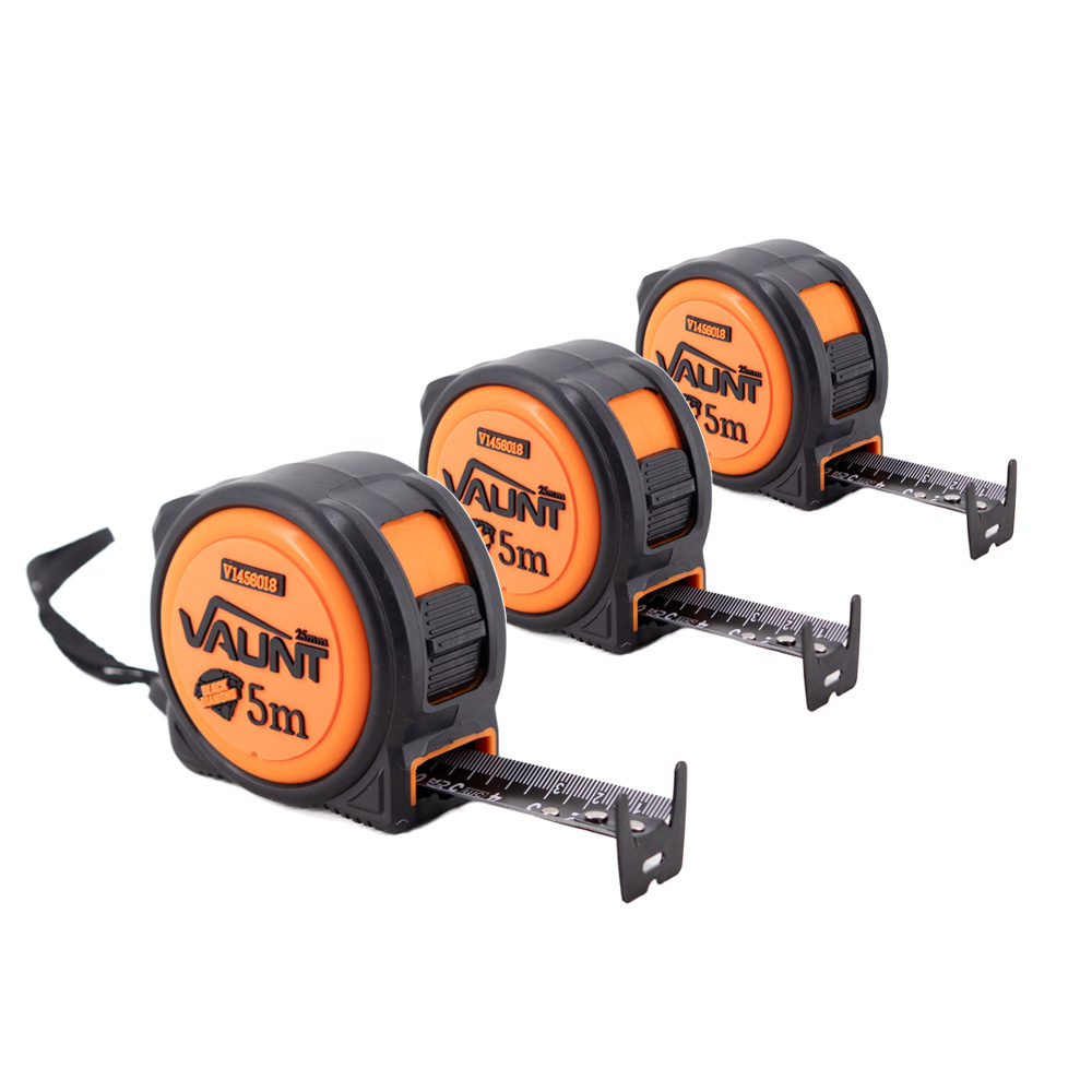 Three orange and black VAUNT 5-meter tape measures are lined up diagonally, each partially extended with the measuring tape visible. The front tape is fully in focus, while the others are slightly behind it.