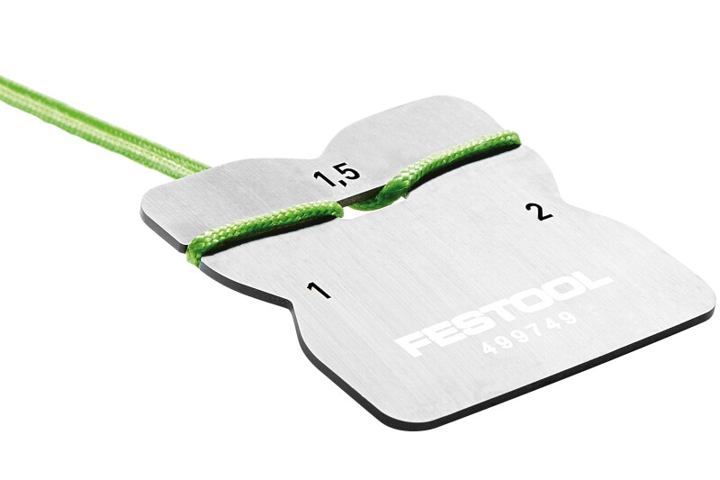 A metal Festool tool with two numbered grooves (1 and 2) and a green string threaded through them; the numbers indicate measurements 1.5 and 2. The tool likely measures or spaces string or rope thickness.