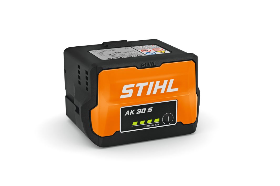 The Stihl AK 30S Battery features an orange and black casing with a battery indicator on the front, ensuring efficient power for your compatible Stihl tools.