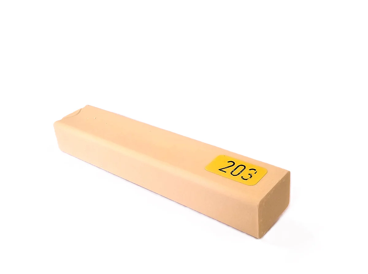 A rectangular beige Konig 8cm Hard Wax Filler Stick Medium Oak with a yellow label on one end, placed on a white background.
