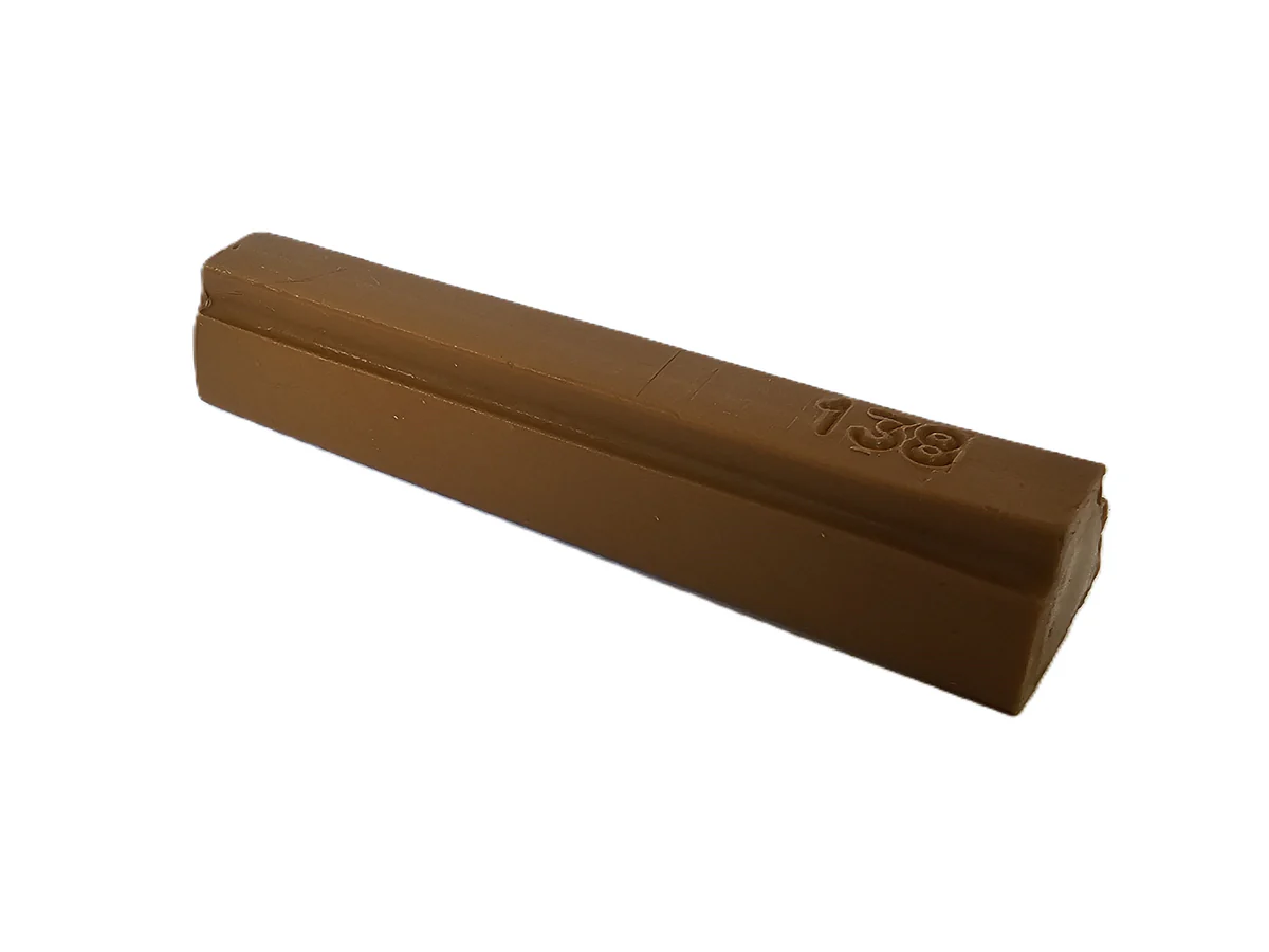 A single unwrapped chocolate bar on a white background, rectangular with rounded edges and a small marking, smooth finish.