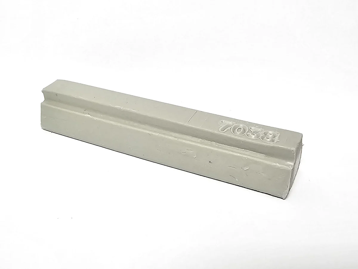 A rectangular soft wax agate grey single 7038 bar with beveled edges and an engraved corner, on a plain white background.