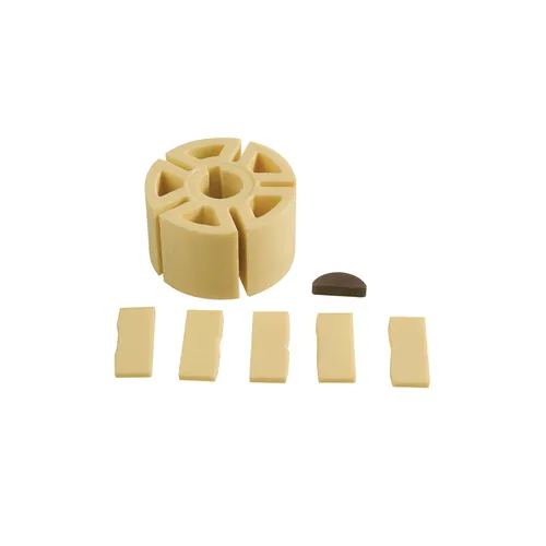 A set of Rotor, Vanes and Jey Jit in light beige plastic with a slotted rotor, five vanes, and a small dark semicircle on white.