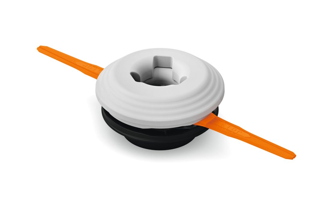 A white and black round trimmer head with two orange blades on opposite sides, designed for a grass or weed trimmer, on white background.