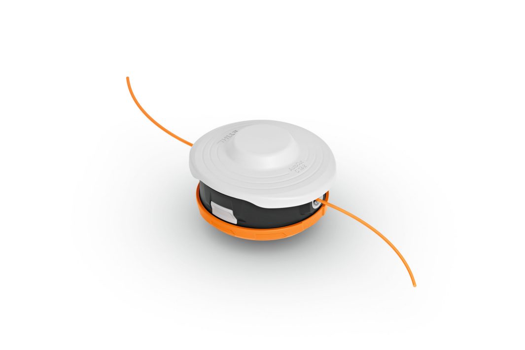 A round black and orange trimmer head with a white cap and two orange trimming lines, used for lawn care, isolated on white.