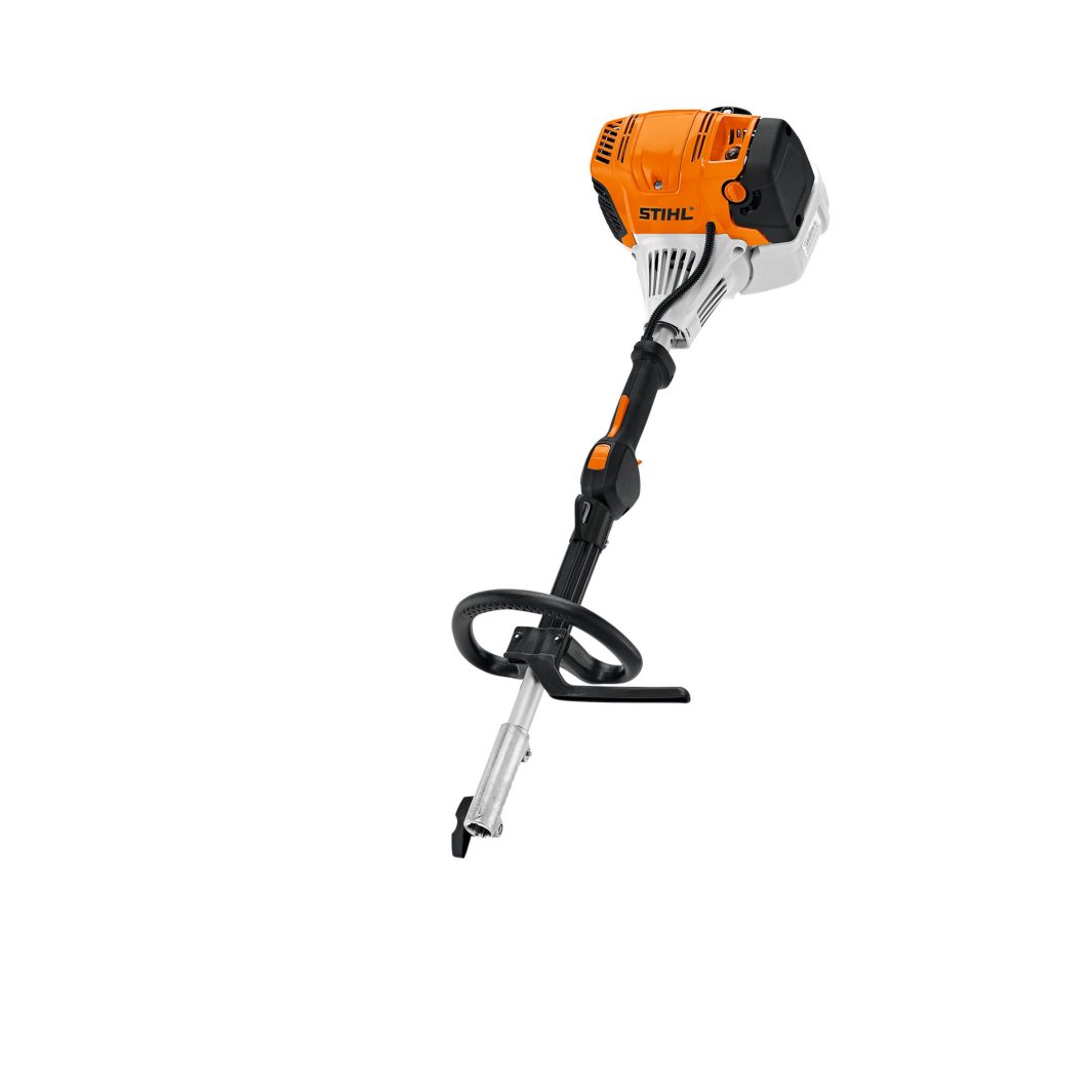 An orange, white, and black STIHL power tool engine with a handle and shaft attachment, standing upright on a white background.