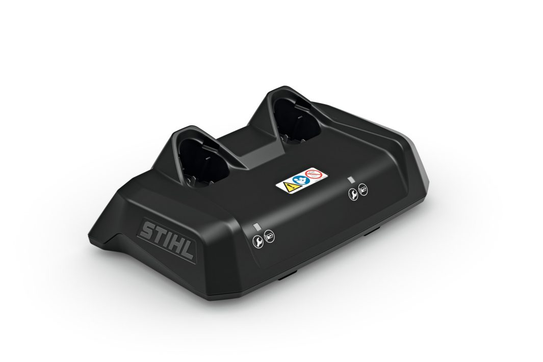 A black STIHL dual battery charging station with two slots, indicator labels, and an angled design on a white background.