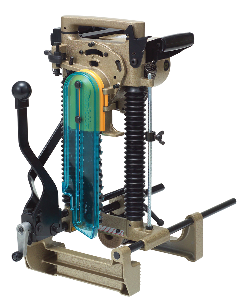 A Makita 7104L chain mortiser (110V) with tan and black metal frame, large vertical spring, levers, and blue/yellow cover.