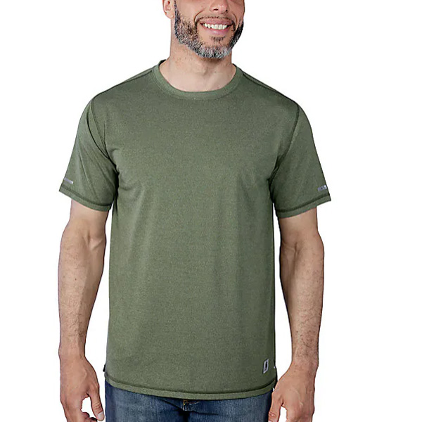A man in a green Carhartt short sleeve T-shirt and blue jeans stands against a white background, smiling and facing forward.