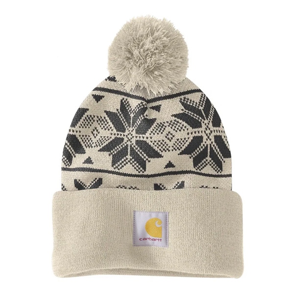The Carhartt AH6647 W Knit Pom Jcqrd Beanie in Oat Milk has a folded brim, black snowflake pattern, pom-pom, and logo patch.