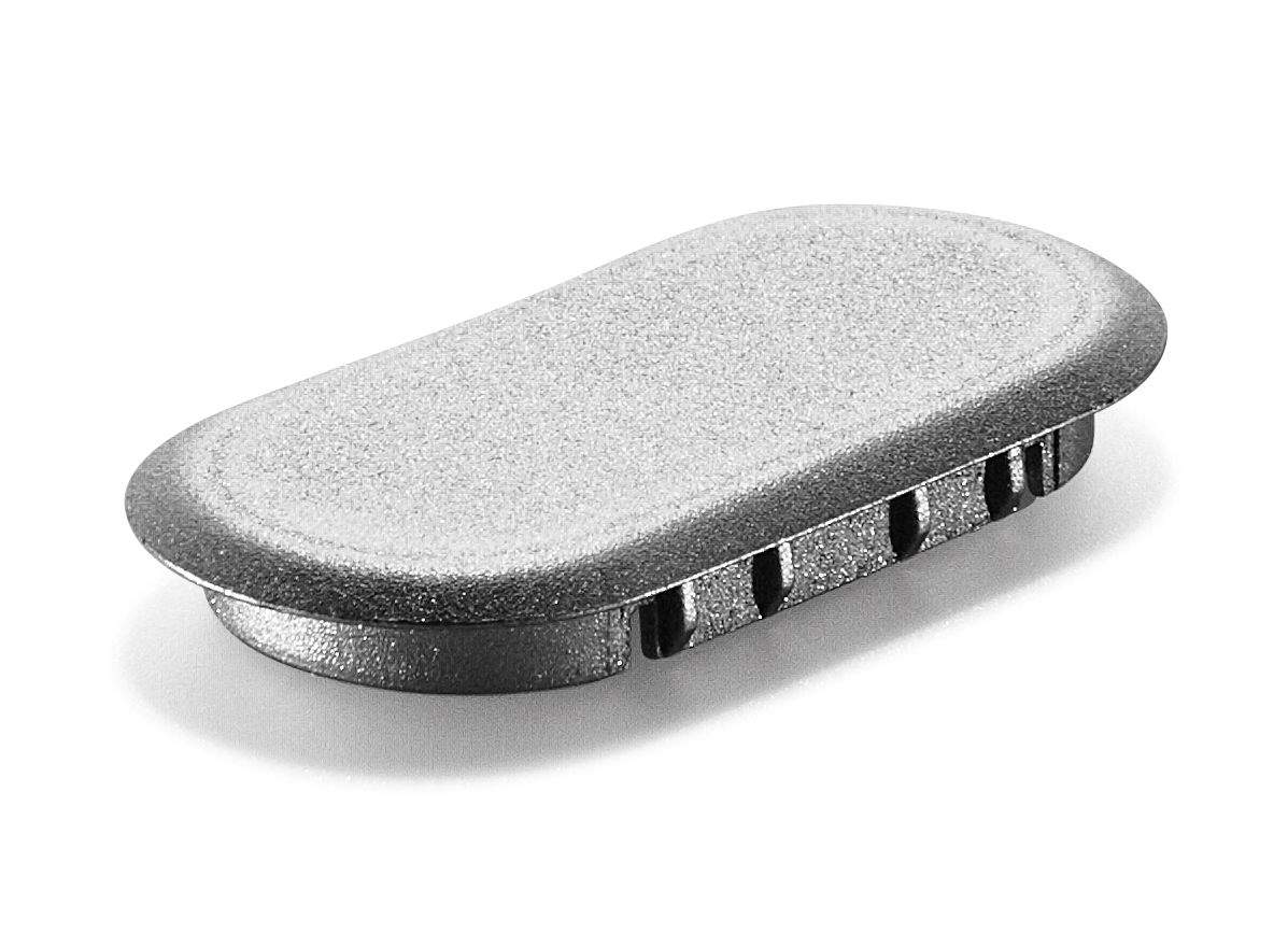 A silver, oval metal plug or cap with a textured surface and slotted sides, designed to fit into an opening, on a white background.