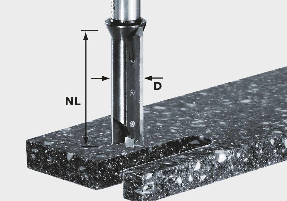 A close-up of the Festool 491110 Reversible blad HW S12 D14/45 WM drill bit cutting a hole in speckled stone.