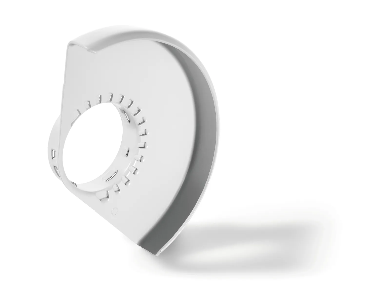 A white curved plastic guard with a circular opening and small rectangular notches, casting a soft shadow on a plain white background.
