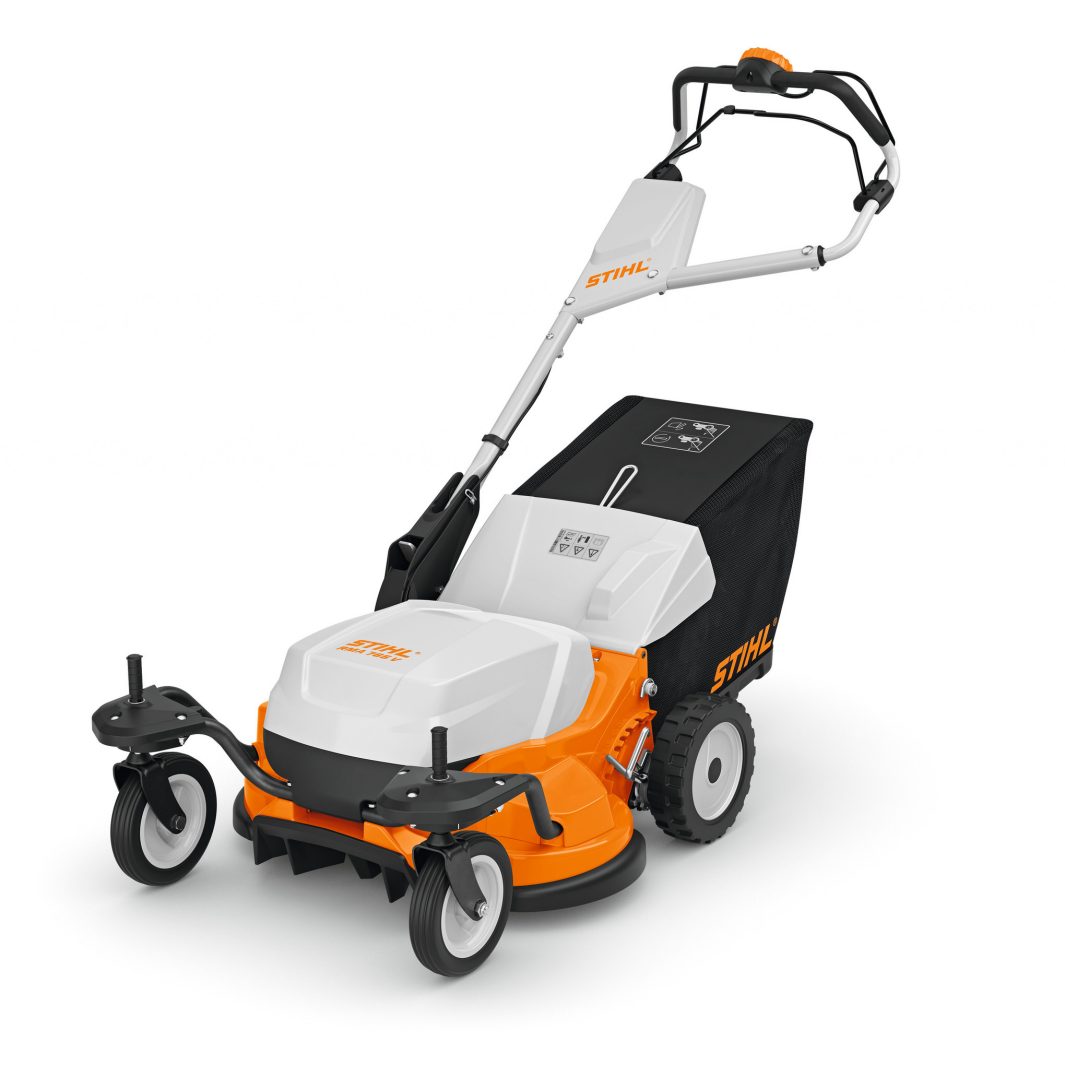 The Stihl RMA 765.0 V (AR) Lawn Mower has a white and orange design, large black rear wheels, small front wheels, and a black bag.