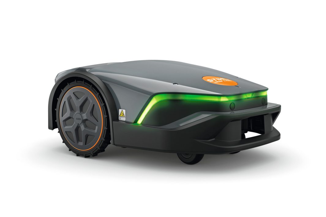 The Stihl IMOW 7.0 PRO Robotic Mower has a sleek black design with orange accents, green front light, and large rear wheels.