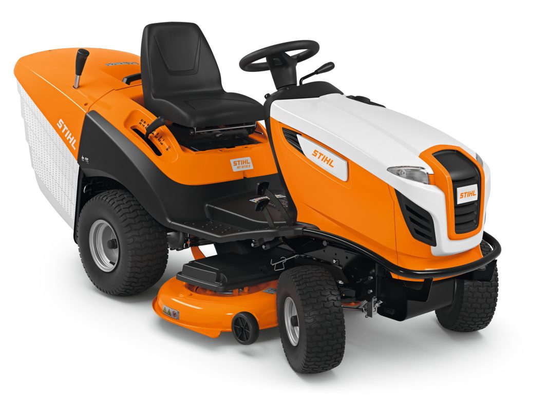 A bright orange and white Stihl RT 5112.1 Z ride-on mower with a black seat, steering wheel, and rear grass box on a white background.