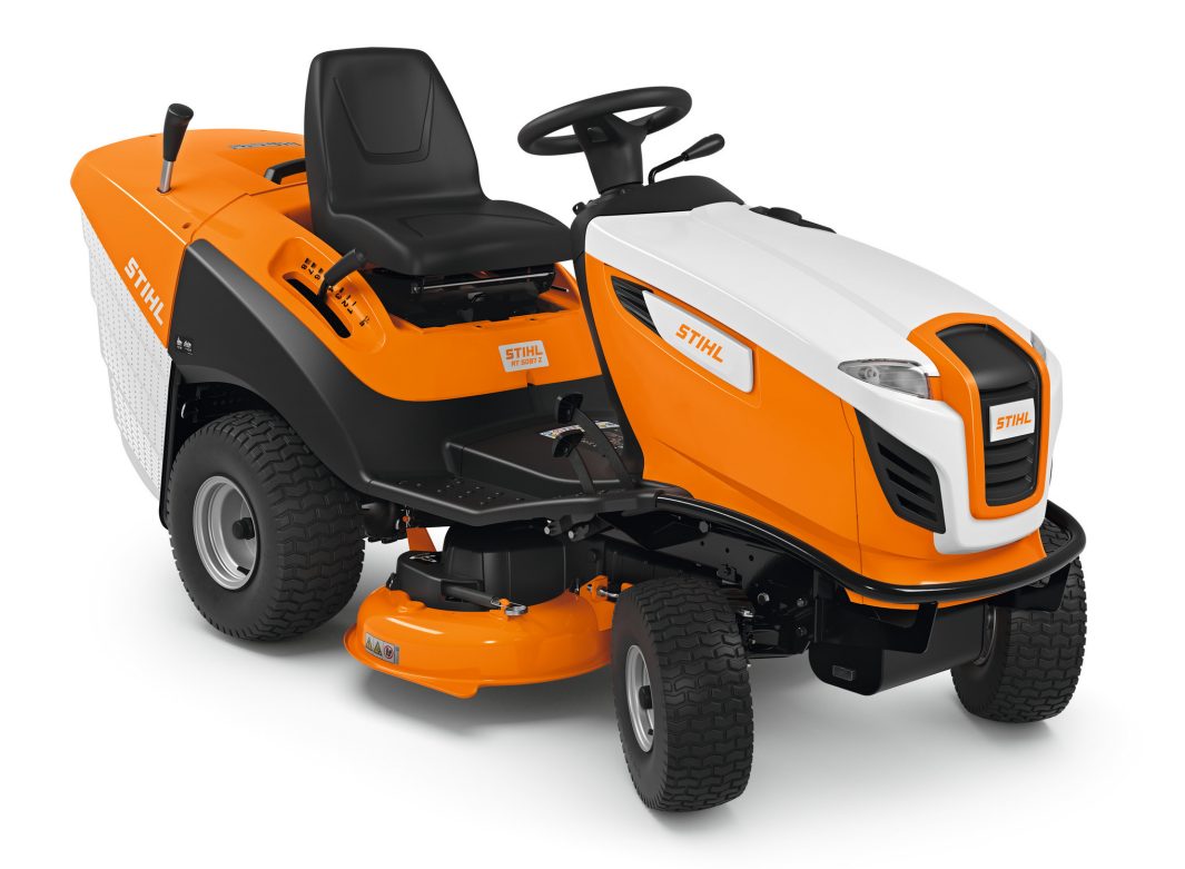 The Stihl RT 5097.1 Z Ride-on Mower has a bright orange and white body, black seat, large rear wheels, steering wheel, and rear grass bag.