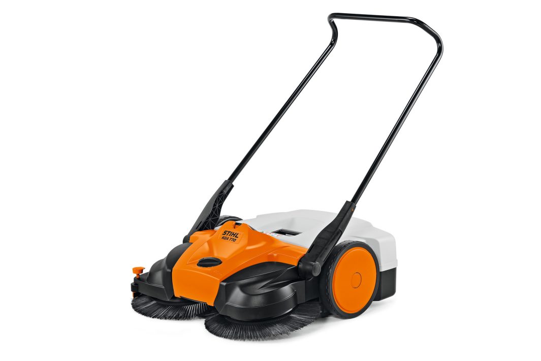 The Stihl KGA 770.0 (AP) Sweeper has orange, black, and white colours, dual front round brushes, large rear wheel, and ergonomic handle.