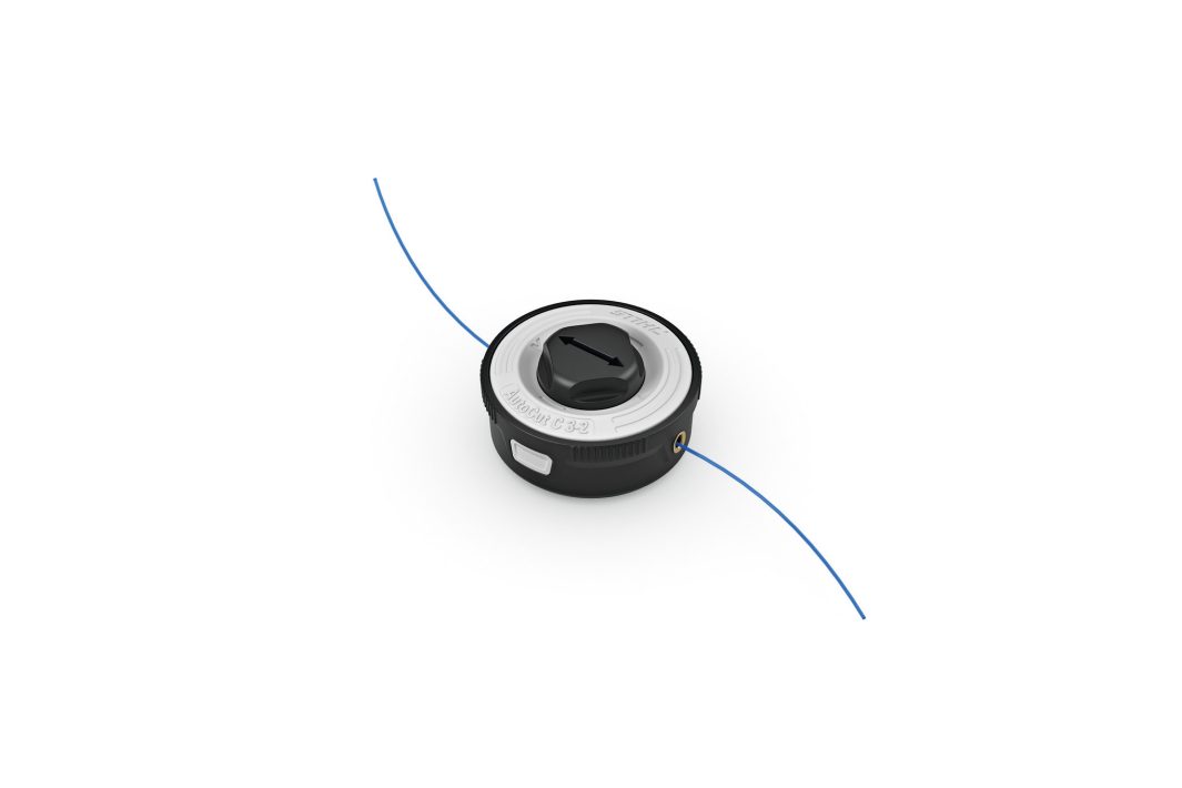 A Stihl AutoCut C 3-2 mowing head in black and silver with a blue strimmer line spool, shown on a white background.