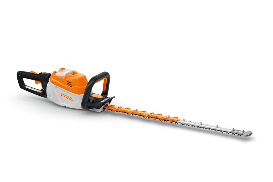 A cordless orange, white, and black STIHL hedge trimmer with a long silver blade and ergonomic handle on a white background.