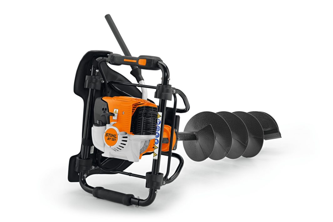 The Stihl BT 131 Earth Auger is a portable orange and black tool with a large spiral bit and sturdy frame for drilling holes in soil.