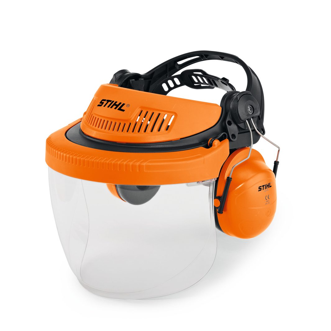 Orange safety helmet with built-in clear face visor and attached orange ear defenders for head, face, and hearing protection in forestry work.