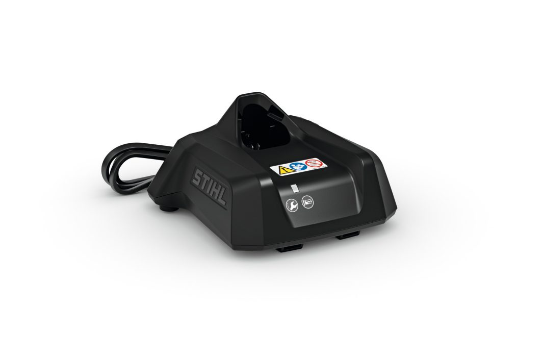 A black STIHL battery charger with a power lead, showing labels on the front, placed on a white background.
