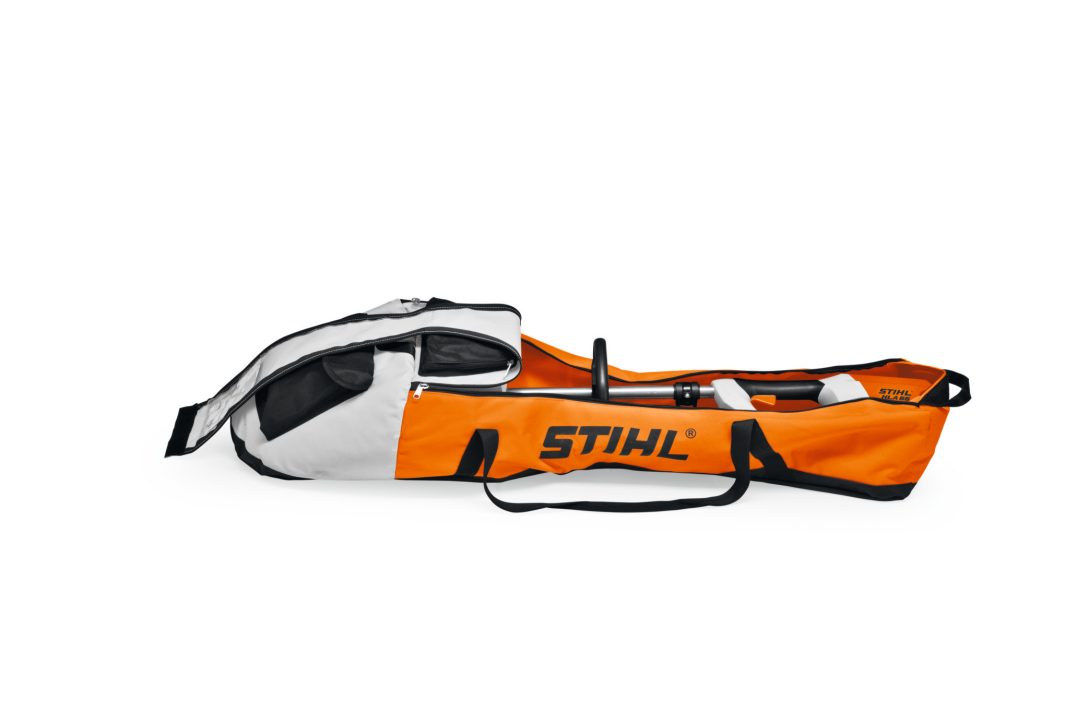 An orange, black, and white STIHL-branded carry bag for power tools, unzipped with a tool inside on a white background.