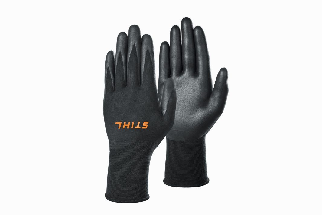 A pair of black Stihl FUNCTION Sensotouch Gloves XL is displayed upright against a white background.