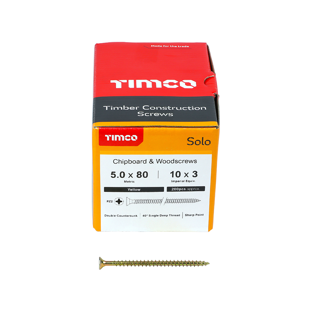 A box of TIMCO Solo timber construction screws with a yellow label. A single gold-coloured screw lies in front of the box.