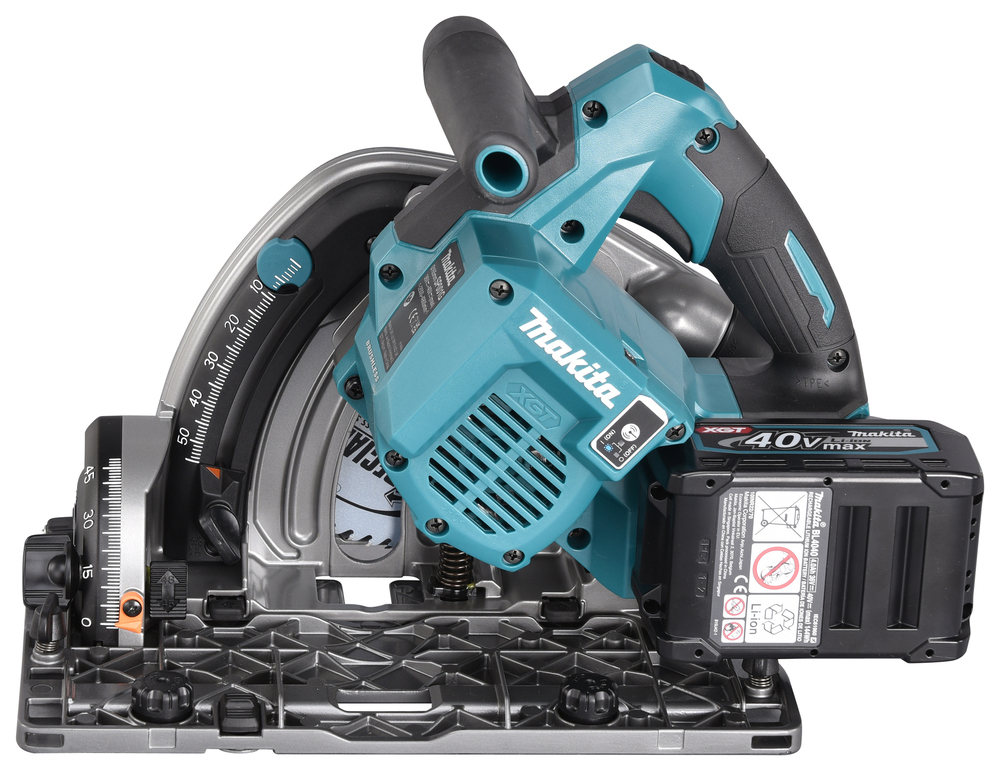 A teal and black Makita 40V cordless circular saw lies on its side, showing the blade, base plate, battery pack, and adjustment gauges.