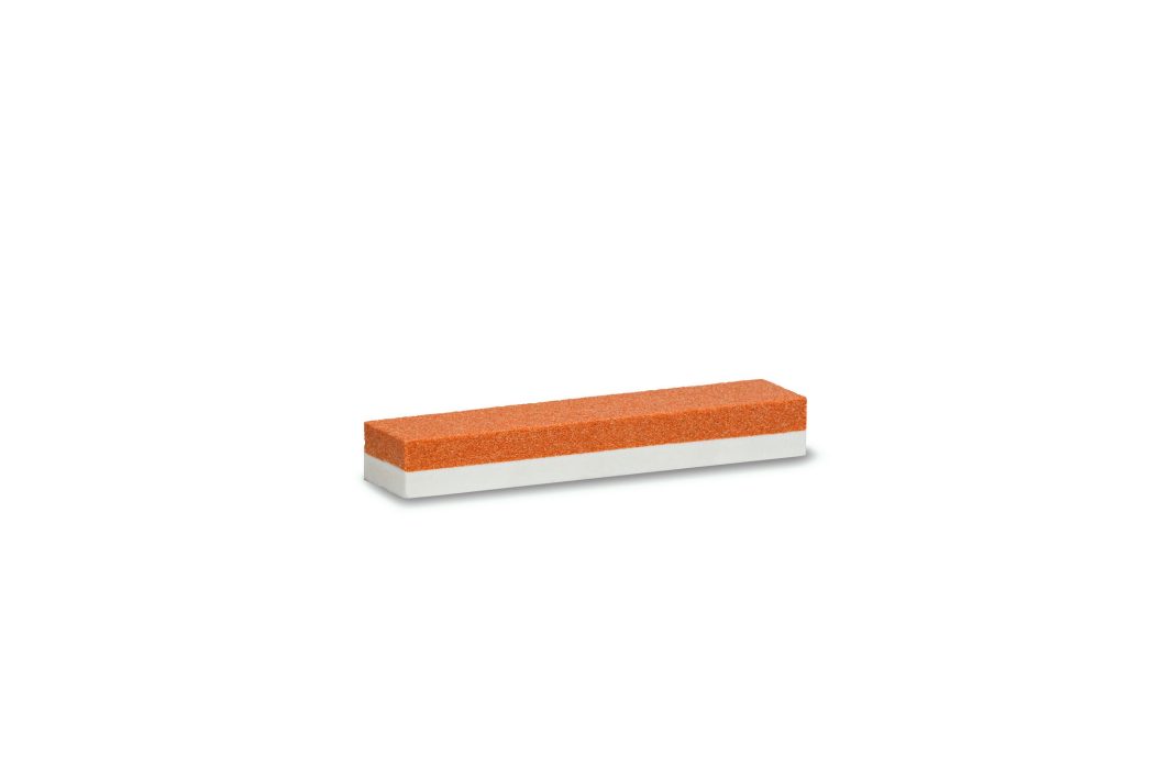 A rectangular sharpening stone with an orange abrasive top and a white base, displayed on a plain white background.