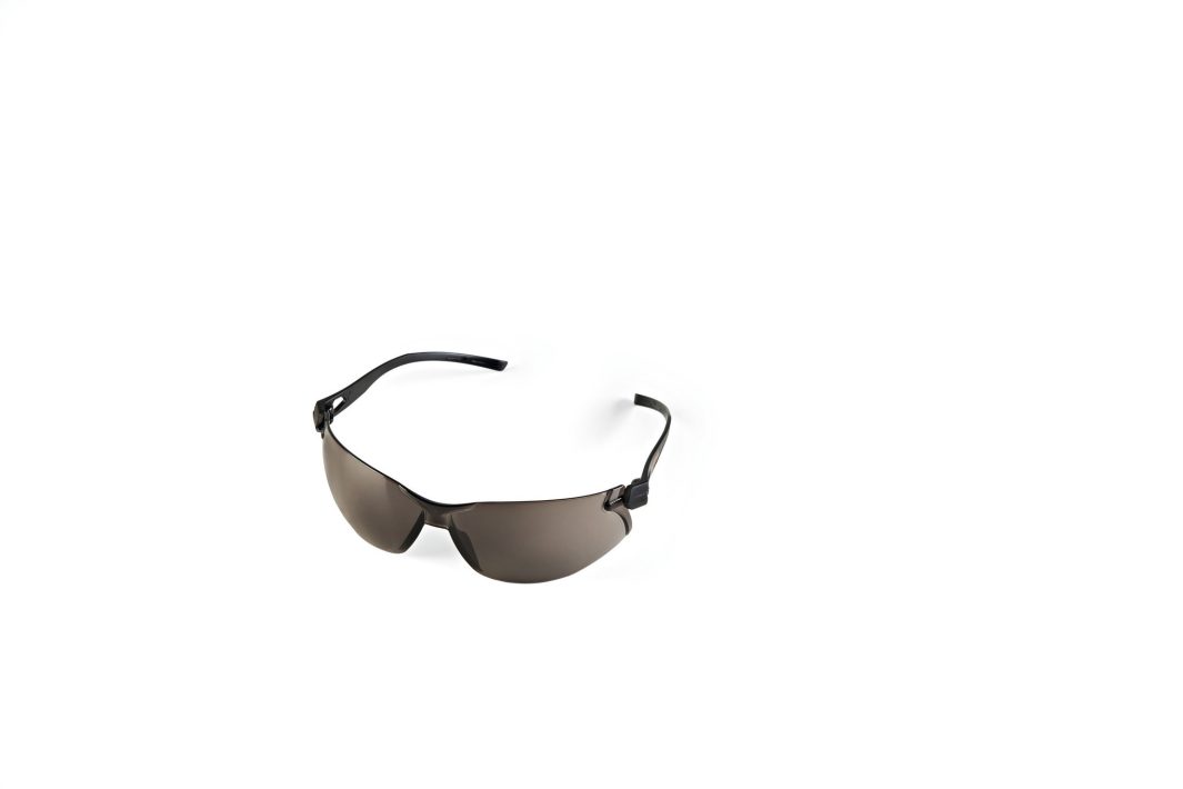 A pair of Stihl Safety glasses FUNCTION Slim, tinted, centred on a white background with ample empty space around them.