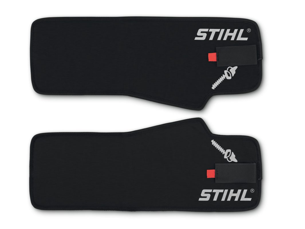 Two black Stihl HS Leg Protection chaps, each with a small saw graphic, are shown lying flat against a white background.