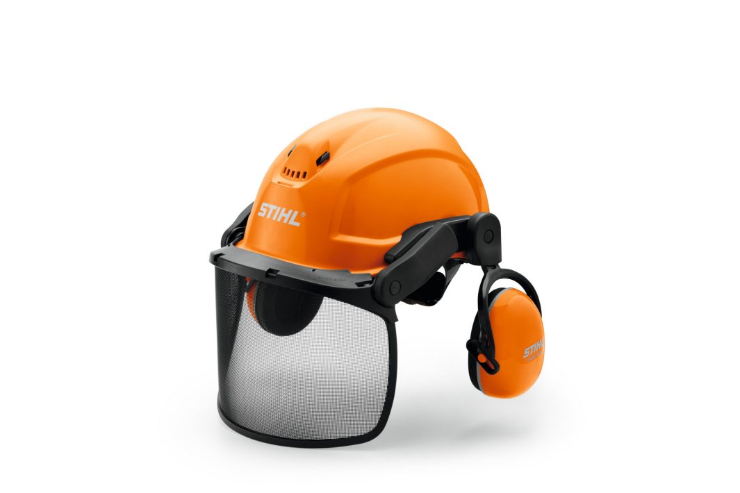An orange STIHL safety helmet with a black mesh visor and over-ear hearing protectors for outdoor or industrial work safety.