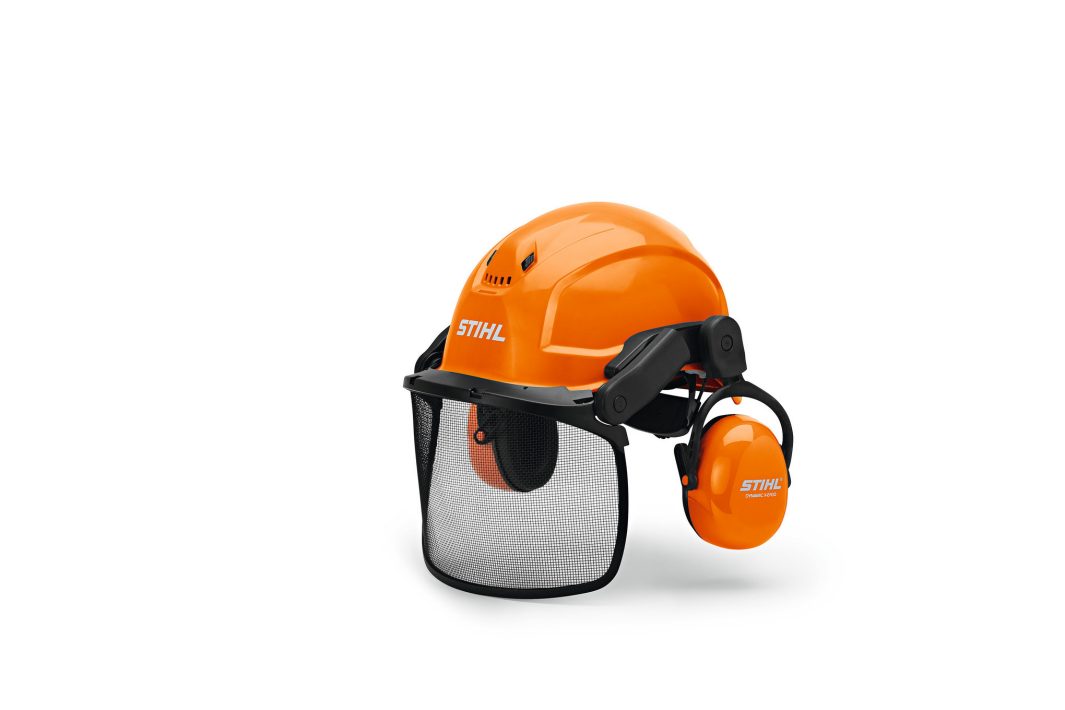 An orange STIHL safety helmet with a mesh visor and ear defenders for protection, displayed against a plain white background.