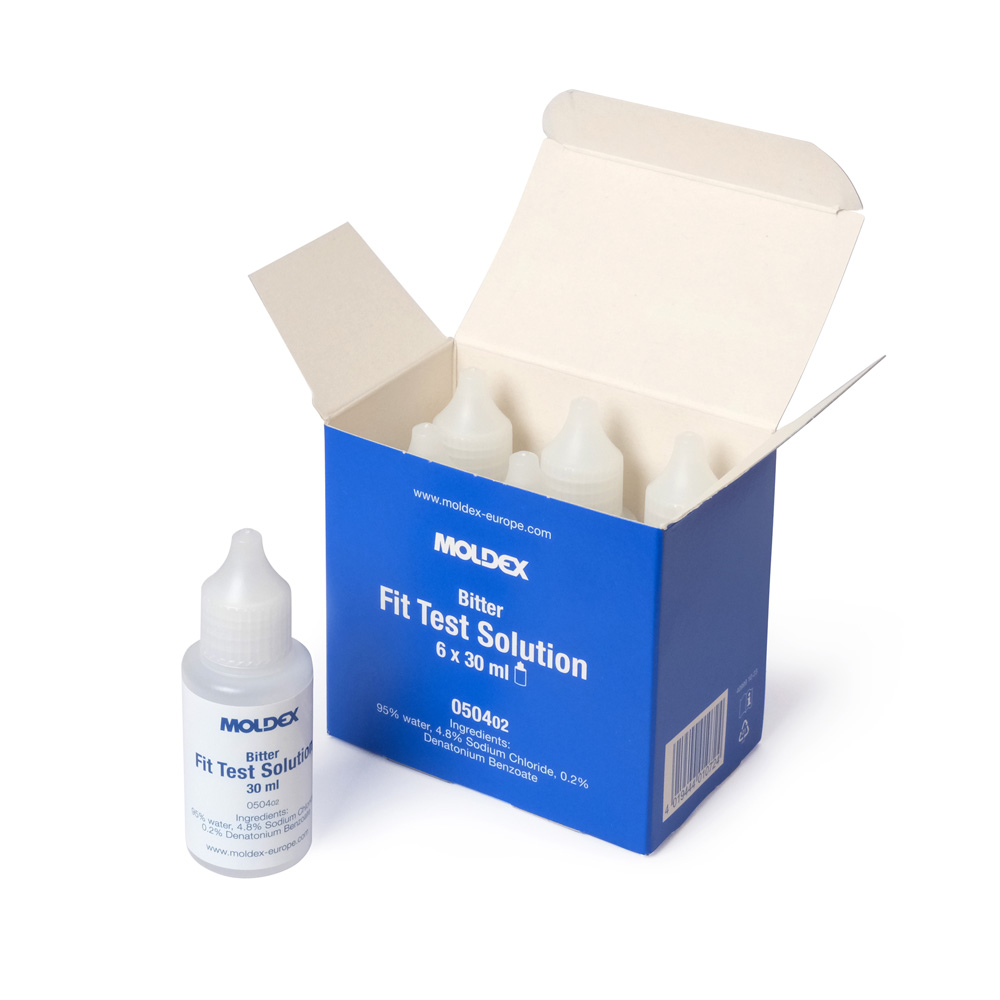 A blue and white box is open, revealing several small plastic bottles inside. One bottle sits outside the box, labelled Fit Test Solution, 30 ml.