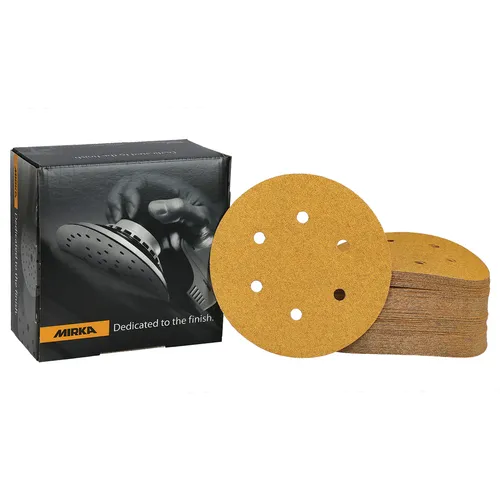 A stack of Mirka Gold 150mm PSA Sanding Discs with 6 holes (100 pieces) sits next to a Mirka-branded box showing a hand holding a sanding tool.