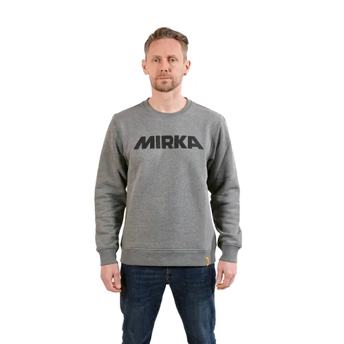 A man stands facing forwards, wearing a Mirka® Jumper Signature Grey and blue jeans, isolated on a white background.