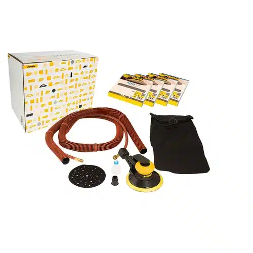Orbital sander kit with a sanding tool, red hose, dust bag, sanding discs, and a white box with yellow graphics, all arranged on a white background.