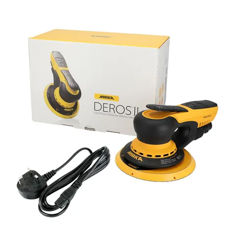A yellow and black Mirka DEROS II electric sander is displayed with its power lead and packaging box in the background. The sander is round with a black handle and yellow base.