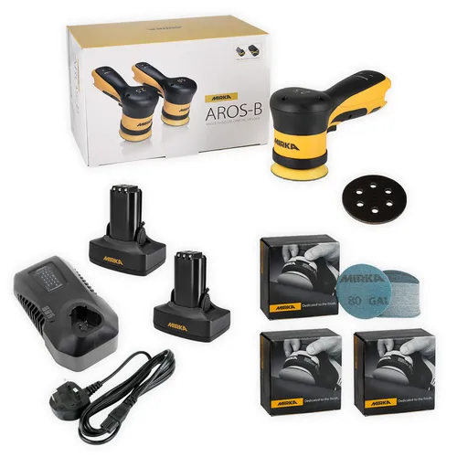 Mirka AROS-B kit with yellow-black sander, two batteries, charger, power cable, sanding discs, boxes of accessories, and product box in the background. All items are neatly arranged on a white surface.