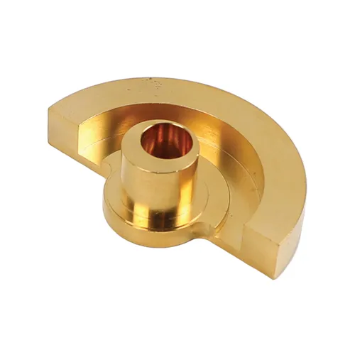A gold-coloured, semi-circular metal component with a central cylindrical hole and raised circular centre, possibly a gear or mechanical part, on a white background.